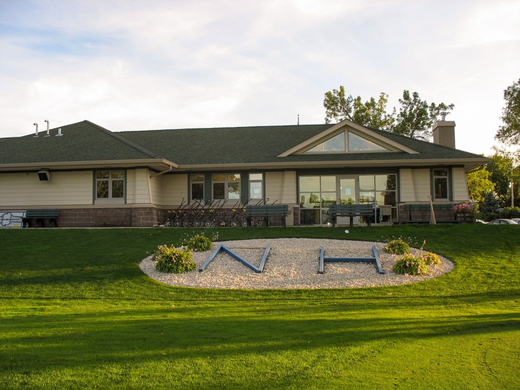 clubhouse with sign in front 